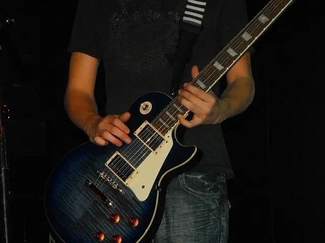 Closeup shot of a guitar held by a person