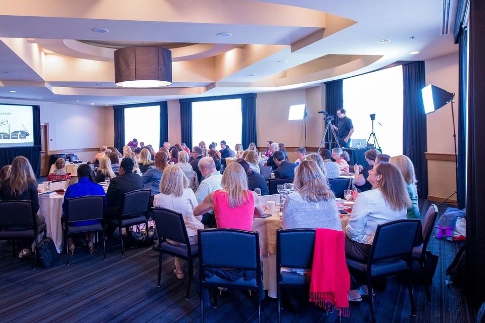 people sitting at tables for a conference