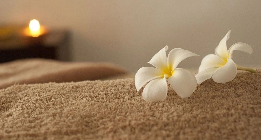 Two White Flowers Lying on the Sand